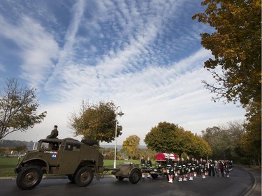 The body of Cpl. Nathan Cirillo is escorted through the streets toward his funeral service.