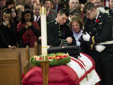 Kathy Cirillo is comforted in front of the coffin of her son Cpl. Cirillo at his regimental funeral service.