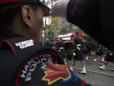 The body of Cpl. Nathan Cirillo is escorted through the streets toward his funeral service.