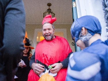 NDP leader Tom Mulcair and his wife, Catherine, hand out Halloween treats Friday evening.
