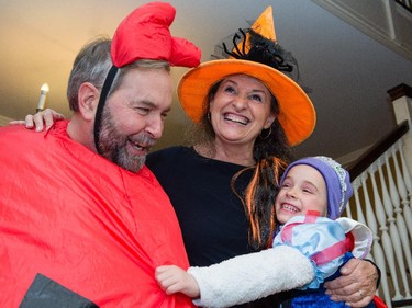 NDP leader Tom Mulcair and his wife Catherine pose with their granddaughter Juliette at their Ottawa home on Halloween.