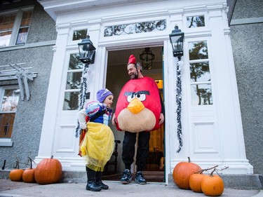 NDP leader Tom Mulcair awaits for tick-or-treaters outside his home Friday evening with his granddaughter Juliette, 5.