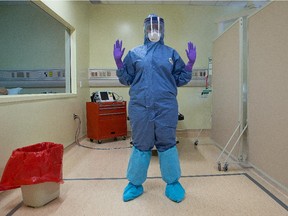 Nurse Nimo Mohamoud of the Ottawa Hospital is training at the Ottawa Health Research Institute at the Civic Campus to wear personal protective equipment required for Ebola patients.  Assignment - 118816 // Photo taken at 14:00 on October 31, 2014.