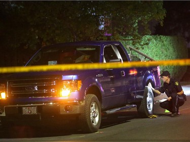 OPP investigate a blue Ford pick-up truck involved in a death on Charles St. near the corner of Daniel St. South in Arnprior, Ontario, Thursday, October 2, 2014. Paramedics found an injured women on the street near a blue pick-up truck, and took her to hospital, where she died. A man was arrested at the scene.