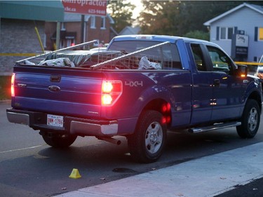 OPP investigate a blue Ford pick-up truck involved in a death on Charles St. near the corner of Daniel St. South in Arnprior, Ontario, Thursday, October 2, 2014. Paramedics found an injured women on the street near a blue pick-up truck, and took her to hospital, where she died. A man was arrested at the scene.