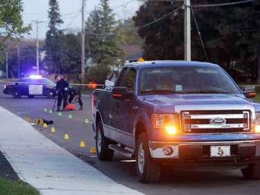 OPP investigate a blue Ford pick-up truck involved in a death on Charles St. near the corner of Daniel St. South in Arnprior, Ontario, Thursday, October 2, 2014. Paramedics found an injured women on the street near a blue pick-up truck, and took her to hospital, where she died. A man was arrested at the scene.