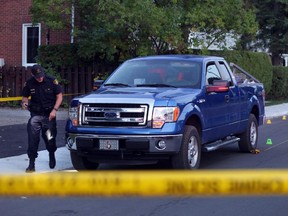 OPP investigate a blue Ford pick-up truck involved in a death on Charles St. near the corner of Daniel St. South in Arnprior, Ontario, Thursday.