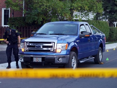 OPP investigate a blue Ford pick-up truck involved in a death on Charles St. near the corner of Daniel St. South in Arnprior, Ontario, Thursday, October 2, 2014. Paramedics found an injured women on the street near a blue pick-up truck, and took her to hospital, where she died. A man was arrested at the scene.