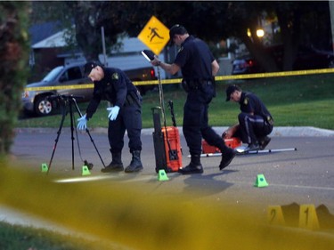 OPP investigate a death on Charles St. near the corner of Daniel St. South in Arnprior, Ontario, Thursday, October 2, 2014. Paramedics found an injured women on the street near a blue pick-up truck, and took her to hospital, where she died. A man was arrested at the scene.