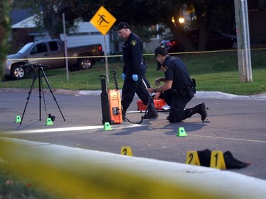 OPP investigate a death on Charles St. near the corner of Daniel St. South in Arnprior, Ontario, Thursday, October 2, 2014. Paramedics found an injured women on the street near a blue pick-up truck, and took her to hospital, where she died. A man was arrested at the scene.