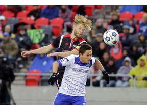 Ottawa Fury defender #6 Richie Ryan and Edmonton FC forward #20 Chad Burt go up to head the ball during NASL soccer action at TD Place in Ottawa, Saturday, October 18, 2014. Ottawa Fury vs. Edmonton FC. TD Place at Lansdowne Park. Mike Carroccetto / Ottawa Citizen