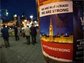 A sign reading, "We are not afraid, We are Strong" is posted in memorial of Cpl. Nathan Cirillo of the Canadian Army Reserves, who was killed while standing guard in front of the National War Memorial by a lone gunman, on October 23, 2014 in Ottawa, Canada.