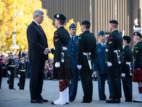 Prime Minister Stephen Harper shakes hands with a soldier in the Canadian Army during a ceremony at the National War Memorial on Oct. 24, two days after the death of Cpl. Nathan Cirillo.