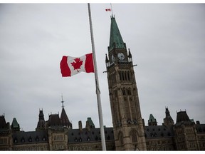 A flag next to the Canadian Parliament Building is flown at half staff one day after Cpl. Nathan Cirillo of the Canadian Army Reserves was killed while standing guard in front of the National War Memorial by a lone gunman, on October 23, 2014 in Ottawa, Canada.