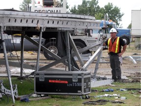 A worker dismantles the collapsed stage at Ottawa Bluesfest in this July 2011 photo.