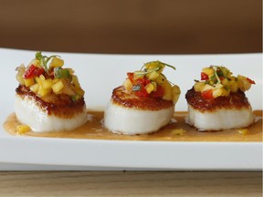 Seared scallops with coconut milk and lemon grass shrimp bisque at Erling's Variety.  (Julie Oliver/Ottawa Citizen)