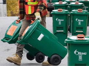 OTTAWA, ONT.-OCTOBER 29, 2009- Nick Leonard delivers green bins along Fairmont Ave on October 29, 2009, as the City Of Ottawa's Green Bin Program for household organics such as potato peelings continues to be rolled out across the region. (Photo by Wayne Cuddington, Ottawa Citizen.)  Assign#