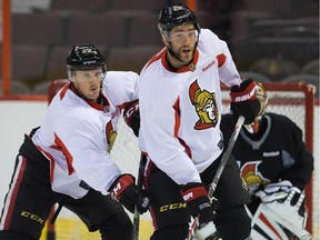 Erik Condra (L) does what he does best against Eric Gryba during a drill.