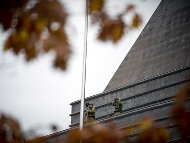 Ottawa Police and RCMP had the downtown core cordon off Wednesday October 22, 2014 after reports of at least one gunman shot and killed a man at the War Monument. Snippers stand guard on the US Embassy in the downtown core.
