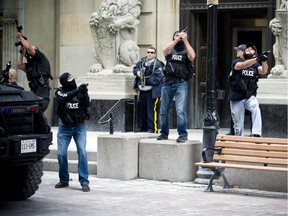 Ottawa Police and RCMP had the downtown core cordon off Wednesday October 22, 2014 after reports of at least one gunman shot and killed a man at the War Monument.
