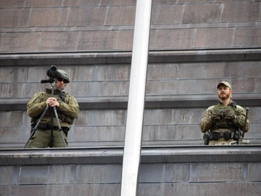 Ottawa Police and RCMP had the downtown core cordon off Wednesday October 22, 2014 after reports of at least one gunman shot and killed a man at the War Monument. Snippers stand guard on the US Embassy in the downtown core.