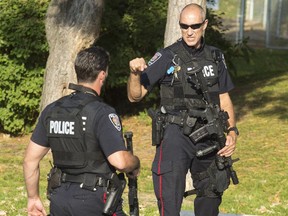 Ottawa police respond to reports that five or six gunshots had been fired in the Pinecrest Terrace housing development on Friday, October 3, 2014.