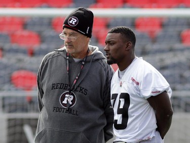 Ottawa RedBlacks running backs coach Don Yanowsky talks to Roy Finch (19) during practice today at TD Place in Ottawa, Monday, October 27, 2014. The RedBlacks take on Hamilton Tiger-Cats this Friday at TD Place.