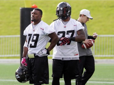 Ottawa RedBlacks running backs (L2R) Roy Finch (19) and Jeremiah Johnson (27) watch a drill during practice today at TD Place in Ottawa, Monday, October 27, 2014. The RedBlacks take on Hamilton Tiger-Cats this Friday at TD Place.