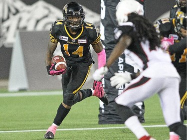Terrell Sinkfield #14 of the Hamilton Tiger-cats runs with the ball against the Ottawa Redblacks.