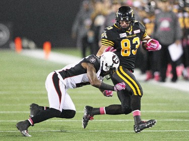 Andy Fantuz #83 of the Hamilton Tiger-cats is about to be taken down against the Ottawa Redblacks.