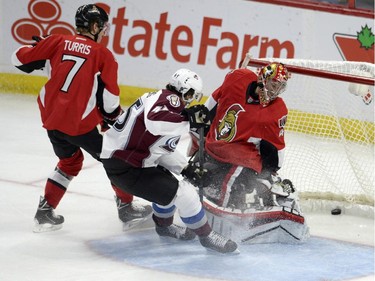 Ottawa Senators goaltender Craig Anderson (41) looks behind him as the puck goes in the net as Colorado Avalanche's Dennis Everberg (45) and Ottawa Senators' Kyle Turris (7) look on during first period NHL action.