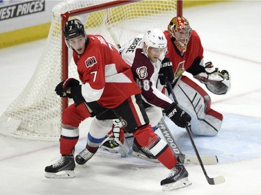 Ottawa Senators' Kyle Turris (7) battles Colorado Avalanche's Jan Hejda (8) as Senators goaltender Craig Anderson (41) watches for the puck during second period NHL action.