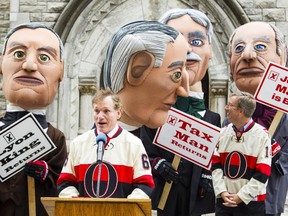Ottawa Senators' President, Cyril Leeder, left, speaks while Ottawa Mayor Jim Watson, right, takes a look at some larger-than-life ex-PMs who will serve as the Senators' newest mascots.