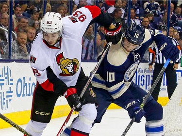 Jack Skille #10 of the Columbus Blue Jackets and Mika Zibanejad #93 of the Ottawa Senators battle for control of the puck during the second period.