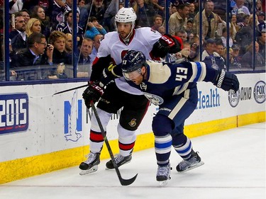 Scott Hartnell #43 of the Columbus Blue Jackets and Jared Cowen #2 of the Ottawa Senators chase after the puck during the second period.