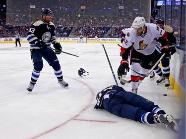 Artem Ansimov #42 of the Columbus Blue Jackets lays on the ice after being hit by Eric Gryba #62 of the Ottawa Senators during the second period. Gryba was given a five minute major penalty and ten minute game misconduct for the hit, and Anisimov did not return to the ice.