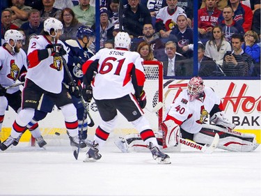 Alexander Wennberg #41 of the Columbus Blue Jackets blocks out Jared Cowen #2 of the Ottawa Senators as a shot from David Savard #58 of the Columbus Blue Jackets beats Robin Lehner #40 of the Ottawa Senators for a goal during the first period.