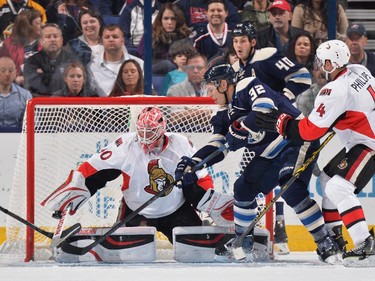 Goaltender Robin Lehner #40 of the Ottawa Senators makes a stick save as Adam Cracknell #32 of the Columbus Blue Jackets attempts to bat the puck into the net during the second period.