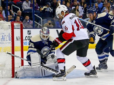 Curtis McElhinney #30 of the Columbus Blue Jackets stops a shot from Clarke MacArthur #16 of the Ottawa Senators during the third period.