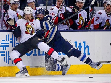Scott Hartnell #43 of the Columbus Blue Jackets and Erik Karlsson #65 of the Ottawa Senators battle for control of the puck during the third period.