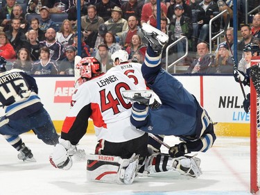 Ryan Murray #27 of the Columbus Blue Jackets flips over the back of goaltender Robin Lehner #40 of the Ottawa Senators during the third period.
