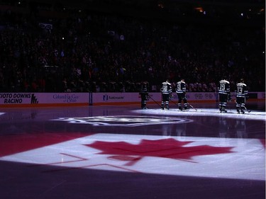 Members of the Columbus Blue Jackets and the Ottawa Senators observe a moment of silence in honor of the Canadian shooting victims prior to the start of their game.