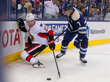 Curtis Lazar #27 of the Ottawa Senators and Jack Johnson #7 of the Columbus Blue Jackets battle for control of the puck during the first period.