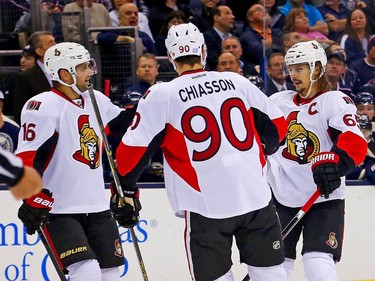 Clarke MacArthur #16 is congratulated by Alex Chiasson #90 and Erik Karlsson #65, all of the Ottawa Senators, after scoring a goal during the first period.