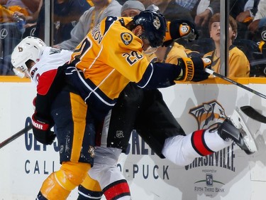 Anton Volchenkov #20 of the Nashville Predators is called for interference against Milan Michalek #9 of the Ottawa Senators.