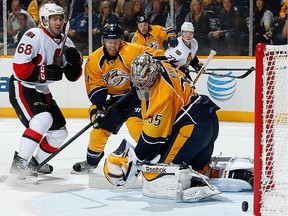 The puck, shot by Mike Hoffman (68) just misses the net during Thursday's game against Nashville.