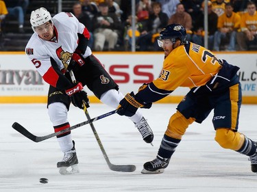 Cody Ceci #5 of the Ottawa Senators battles against Colin Wilson #33 of the Nashville Predators.