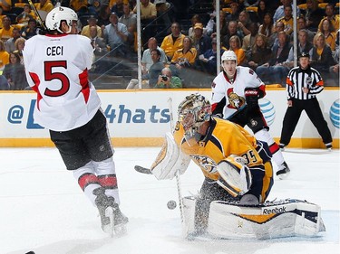 Pekka Rinne #35 of the Nashville Predators makes the save against Cody Ceci #5 of the Ottawa Senators.