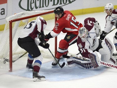 Ottawa Senators' Zack Smith (15) scores on Colorado Avalanche goaltender Calvin Picard (31) as Avalanche teammates Dennis Everberg (45) and Tyson Barrie (4) defend during first period NHL action.