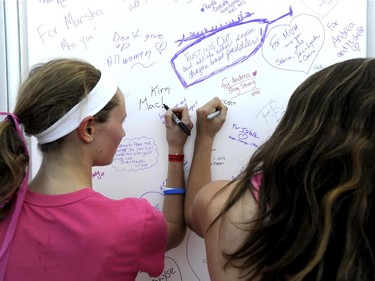 Participants write on the Wall of Hope at the CIBC Run for the Cure in Ottawa on Sunday, October 5, 2014. 7, 100 participants gathered at Tunney's Pasture for the annual event's 23rd year.
